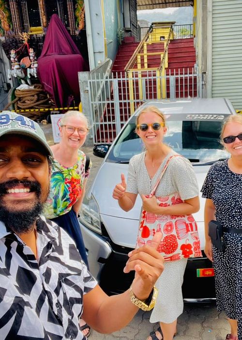 Guests with the Ceylon Loop team beside their van